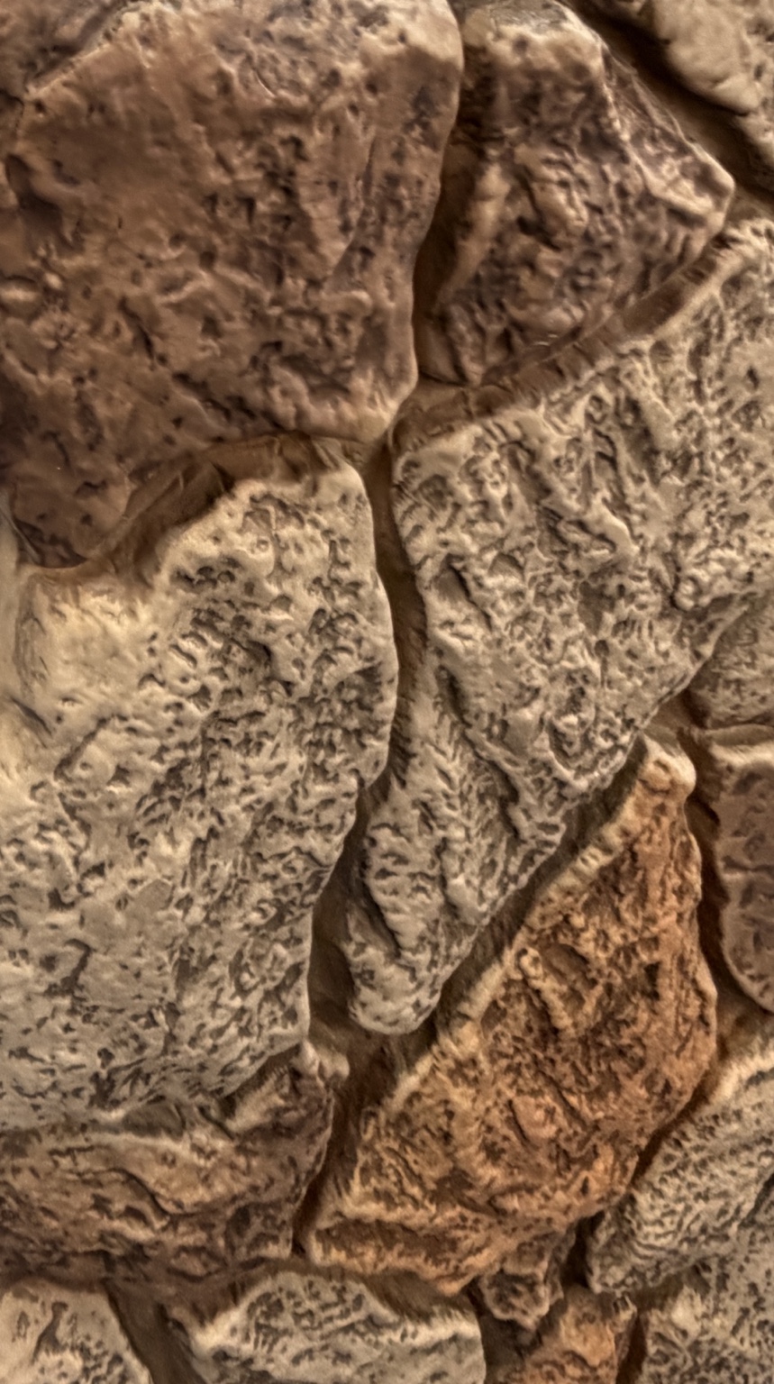Decorative panels with a textured stone-look surface in gray and warm brown tones